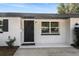 The home's front entrance features a black security door and a stylish welcome mat at 3118 Clemwood St, Orlando, FL 32803