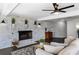 Living room features a whitewashed brick fireplace and hardwood floors at 3118 Clemwood St, Orlando, FL 32803