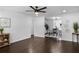 Open concept living and dining area with dark hardwood floors and ceiling fan at 3118 Clemwood St, Orlando, FL 32803