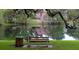 Serene pond view with a wooden bench, lush greenery, and hanging moss creating a tranquil atmosphere at 3118 Clemwood St, Orlando, FL 32803