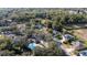 Aerial view of homes in a wooded community with a pool and mature trees at 3442 Starbird Dr, Ocoee, FL 34761