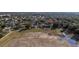 Aerial view of neighborhood showing the proximity to the community lake and mature trees at 3442 Starbird Dr, Ocoee, FL 34761