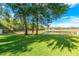 Large, well-maintained backyard with a view of a pond and a black metal fence at 3442 Starbird Dr, Ocoee, FL 34761