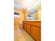 Bathroom featuring a double sink vanity with decorative mirror and fixtures at 3442 Starbird Dr, Ocoee, FL 34761