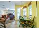 Bright breakfast nook features a tiled table and chairs, with views into the living room at 3442 Starbird Dr, Ocoee, FL 34761