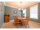 Charming dining room with hardwood table and chairs, chandelier, and bright windows at 3442 Starbird Dr, Ocoee, FL 34761