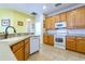 Traditional kitchen featuring warm wood cabinetry and white appliances at 3442 Starbird Dr, Ocoee, FL 34761