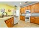 Kitchen with light wood cabinets, stainless steel appliances, and tile floor at 3442 Starbird Dr, Ocoee, FL 34761