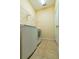 Functional laundry room with tile flooring, utility sink, and storage shelf at 3442 Starbird Dr, Ocoee, FL 34761