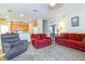 Bright living room with two red sofas and an armchair at 3442 Starbird Dr, Ocoee, FL 34761