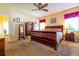 Spacious bedroom with carpet, complemented by warm lighting and a ceiling fan at 3442 Starbird Dr, Ocoee, FL 34761