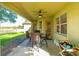 Covered patio features a ceiling fan, outdoor dining set, and views of the backyard at 3442 Starbird Dr, Ocoee, FL 34761
