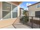 Charming balcony with wrought iron railing and views of neighboring homes and lush landscaping at 417 Pavia Loop, Lake Mary, FL 32746