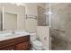 Well-lit bathroom with glass shower, vanity with dark wood cabinet and sink at 417 Pavia Loop, Lake Mary, FL 32746