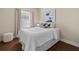 Comfortable bedroom with a large window, white bedding, and stylish decor at 417 Pavia Loop, Lake Mary, FL 32746