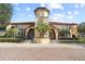 A beautiful clubhouse with stucco walls, a tower and terracotta roof tiles at 417 Pavia Loop, Lake Mary, FL 32746