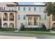 Elegant two-story townhouse featuring a tile roof and a beautifully landscaped entrance at 417 Pavia Loop, Lake Mary, FL 32746