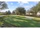 Community putting green with sand trap and shade trees at 417 Pavia Loop, Lake Mary, FL 32746