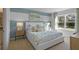 Bright bedroom with a white bed and blue accent wall at 4245 Singing Mockingbird Blvd, Bartow, FL 33830