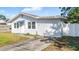 Charming one story home with a white exterior and a small yard at 4401 Santee St, Orlando, FL 32804