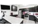 Modern kitchen with black cabinetry, stainless steel appliances, and white counters at 4401 Santee St, Orlando, FL 32804