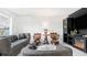 Living room with gray sofas, dark wood accent chairs, and fireplace at 4401 Santee St, Orlando, FL 32804