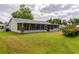 Expansive backyard with lawn and screened-in patio, perfect for outdoor enjoyment at 4818 Breezy Palms Ct, Windermere, FL 34786