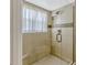 Bathroom features a glass enclosed shower with tile and neutral decor at 4818 Breezy Palms Ct, Windermere, FL 34786