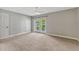 Bedroom featuring neutral carpet, ceiling fan, and sliding glass doors to the yard at 4818 Breezy Palms Ct, Windermere, FL 34786