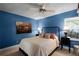 Bedroom with ceiling fan and NYC-themed art at 4818 Breezy Palms Ct, Windermere, FL 34786