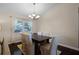 Bright dining room featuring hardwood floors and large windows at 4818 Breezy Palms Ct, Windermere, FL 34786