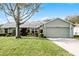 Single-story house with attached garage and well-maintained lawn at 4818 Breezy Palms Ct, Windermere, FL 34786