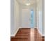 Inviting foyer with wood floors, showcasing a bright entry door and neutral wall color at 4818 Breezy Palms Ct, Windermere, FL 34786