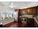 Well-equipped kitchen featuring dark wood cabinets and stainless steel appliances at 4818 Breezy Palms Ct, Windermere, FL 34786