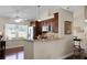 Kitchen with dark wood cabinets and granite countertops at 4818 Breezy Palms Ct, Windermere, FL 34786