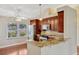 Updated kitchen featuring wooden cabinets, granite countertops, stainless steel appliances, and natural light at 4818 Breezy Palms Ct, Windermere, FL 34786