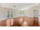 Spacious living room featuring hardwood floors and natural light from doors to exterior at 4818 Breezy Palms Ct, Windermere, FL 34786
