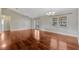 Large living area featuring hardwood flooring, ceiling fan, and sliding doors to exterior at 4818 Breezy Palms Ct, Windermere, FL 34786