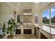 Outdoor kitchen with stainless steel appliances and granite countertops at 4818 Breezy Palms Ct, Windermere, FL 34786