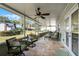 Relaxing screened porch with seating and ceiling fan at 4818 Breezy Palms Ct, Windermere, FL 34786