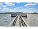 Wooden dock extending over calm lake water at 50989 Highway 27 # 25, Davenport, FL 33897