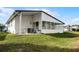 Home's back exterior with screened porch and AC unit at 50989 Highway 27 # 25, Davenport, FL 33897