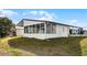 View of home's exterior, highlighting the screened porch at 50989 Highway 27 # 25, Davenport, FL 33897