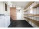 Laundry area with shelving and brick accent wall at 50989 Highway 27 # 25, Davenport, FL 33897