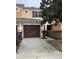 Front view of townhome featuring a brown garage door and walkway at 538 Bexley Dr, Davenport, FL 33897