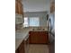 View of kitchen with wood cabinets, stainless steel appliances, and double sink at 538 Bexley Dr, Davenport, FL 33897