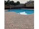 Community pool with surrounding brick patio at 538 Bexley Dr, Davenport, FL 33897