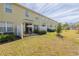 Backyard patio with seating area and lawn at 54 Bella Oaks Dr, Port Orange, FL 32129