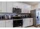 White shaker cabinets and stainless steel appliances in this kitchen at 54 Bella Oaks Dr, Port Orange, FL 32129