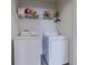 Laundry room with washer, dryer, and shelving at 54 Bella Oaks Dr, Port Orange, FL 32129